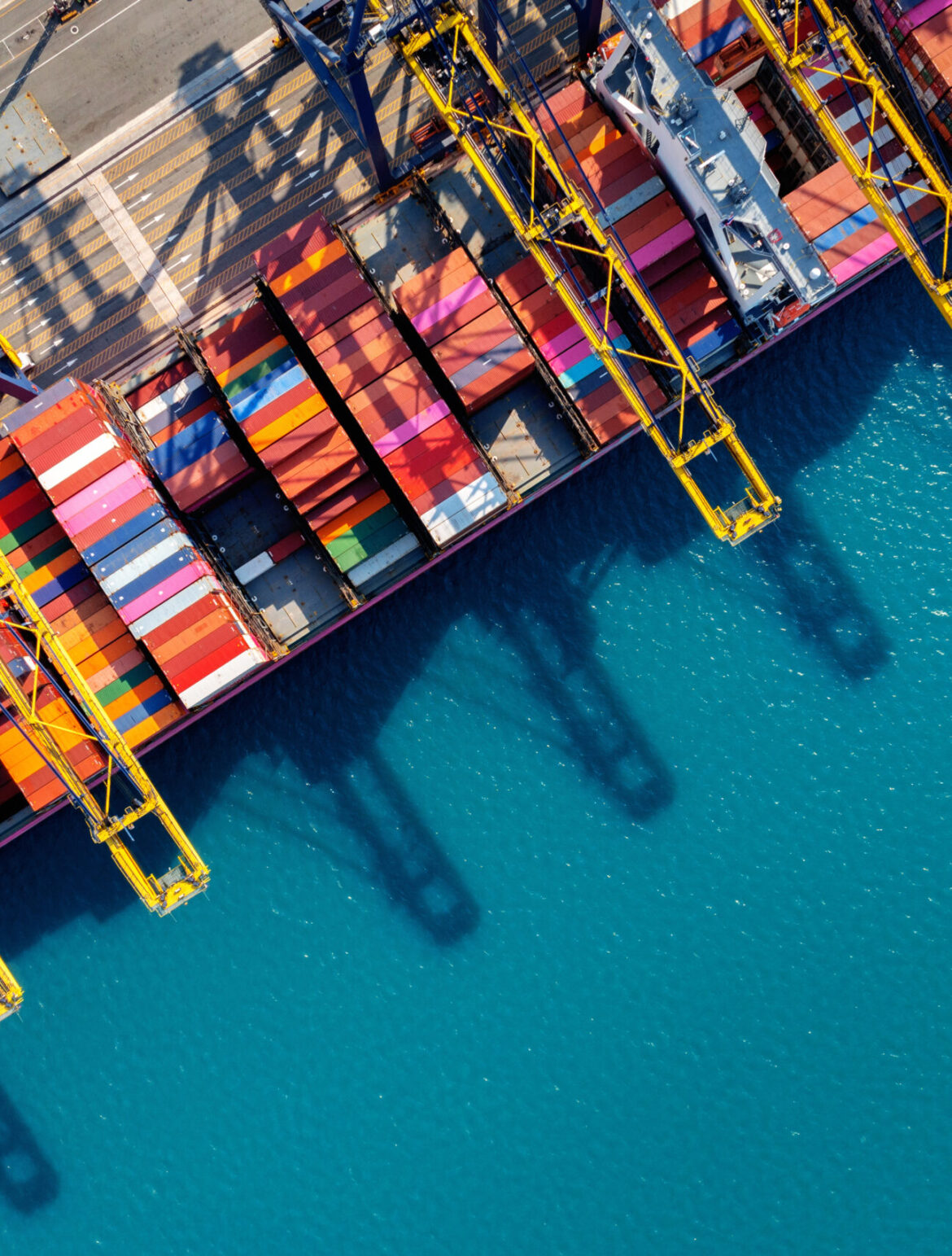 Aerial view of cargo ship and cargo container in harbor.